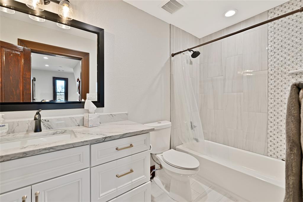 304 North Church Street Pilot Point, TX 76258 - Photo 30 of 40 a bathroom with a granite countertop sink toilet and shower