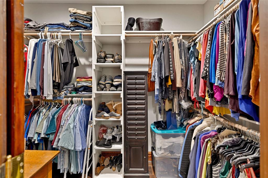 304 North Church Street Pilot Point, TX 76258 - Photo 33 of 40 a view of walk in closet with clothes and shoes