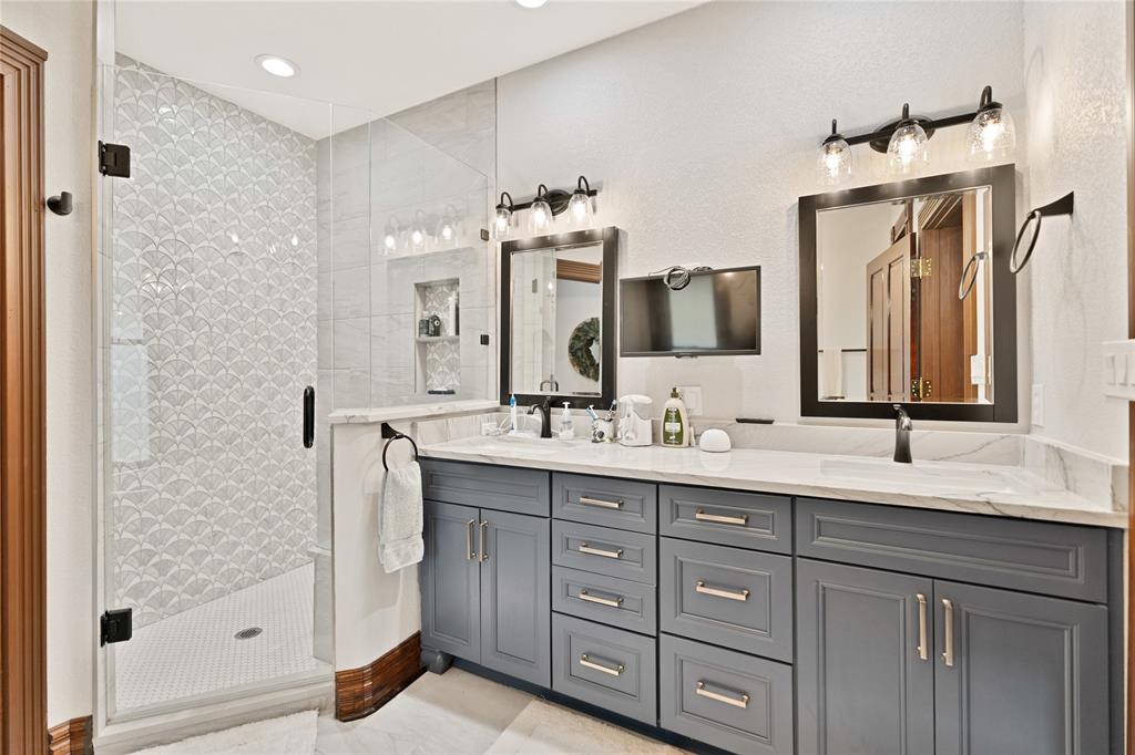 304 North Church Street Pilot Point, TX 76258 - Photo 36 of 40 a bathroom with a double vanity sink mirror and double
