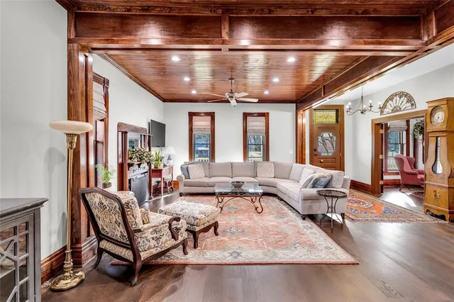 a living room with furniture and a chandelier