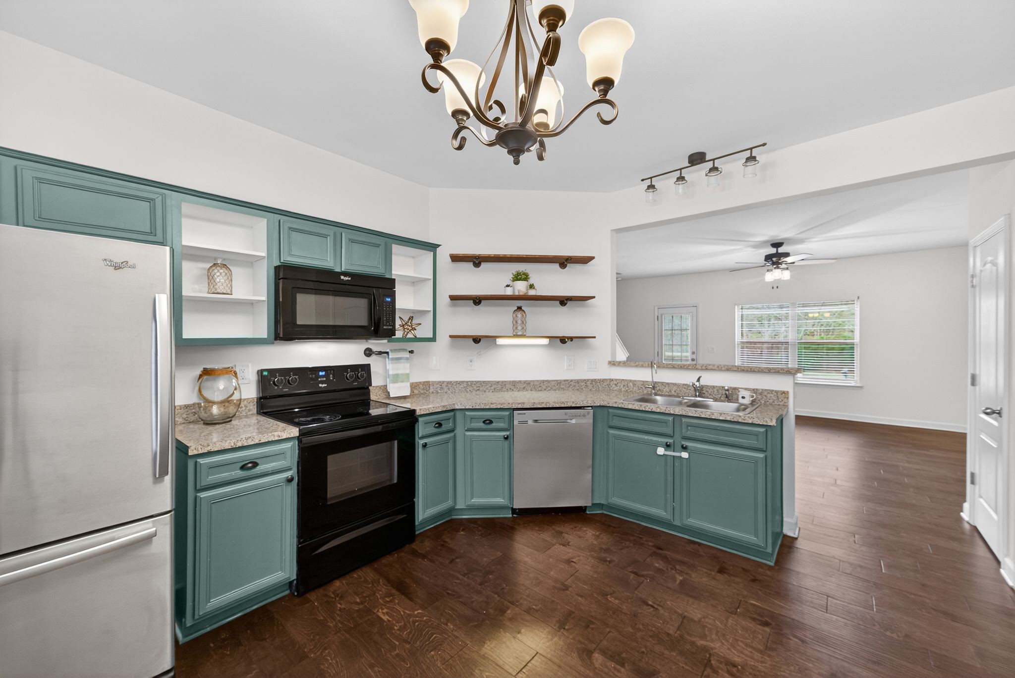 735 Tulip Grove Road, Unit 358 Hermitage, TN 37076 - Photo 11 of 37 a kitchen with stainless steel appliances granite countertop a stove top oven a sink dishwasher and a refrigerator with wooden floor