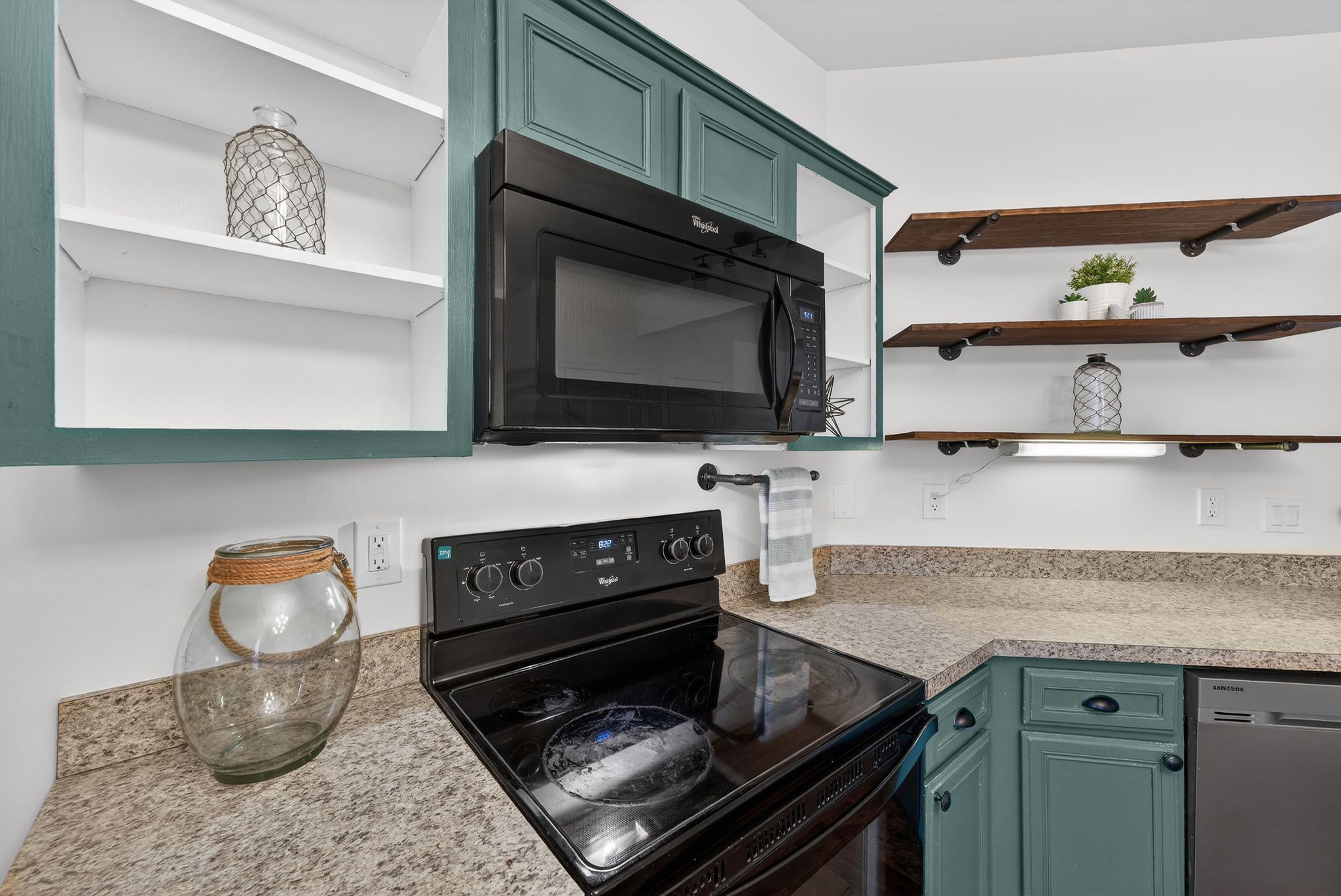 735 Tulip Grove Road, Unit 358 Hermitage, TN 37076 - Photo 13 of 37 a kitchen with stainless steel appliances granite countertop a stove and a microwave
