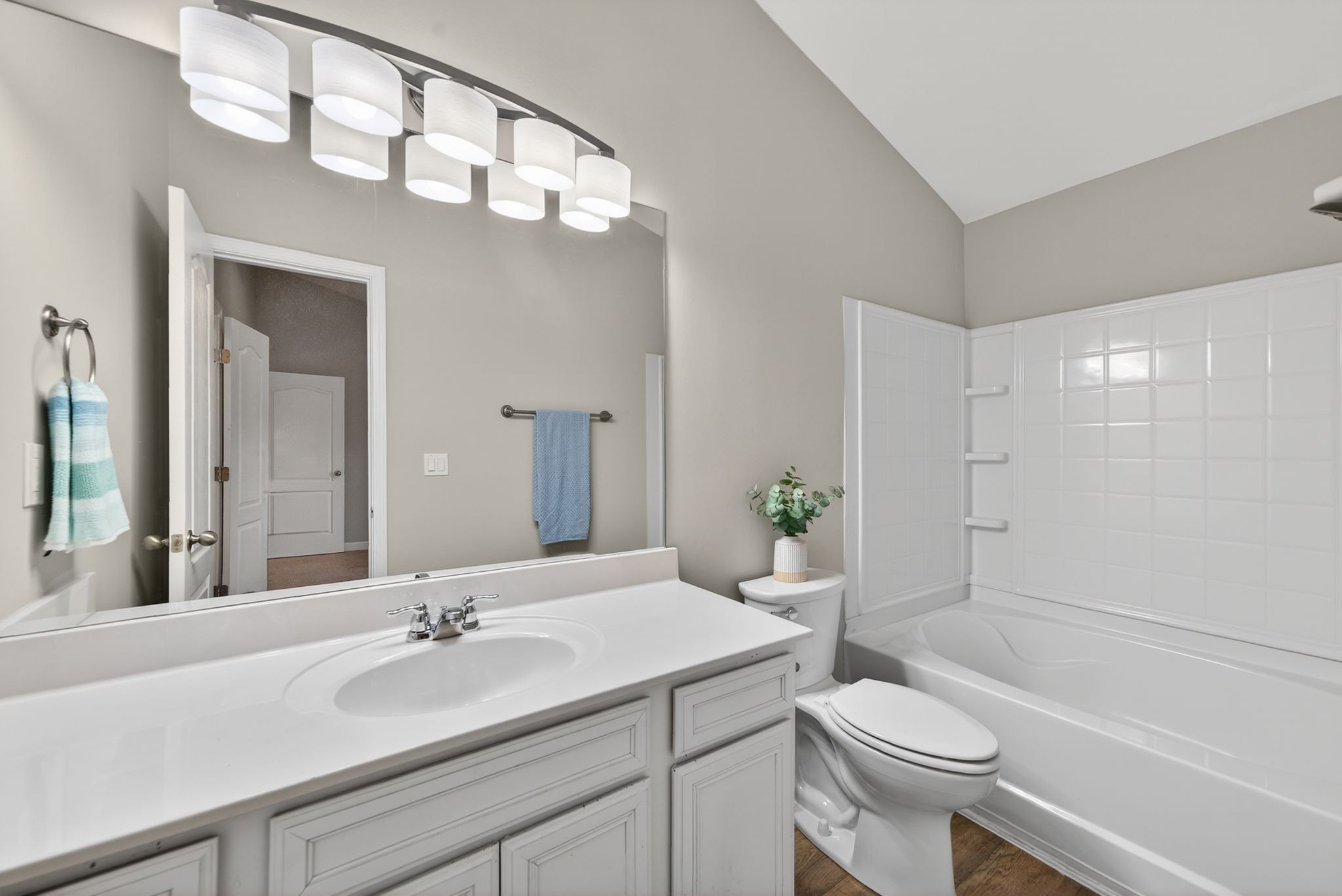 735 Tulip Grove Road, Unit 358 Hermitage, TN 37076 - Photo 23 of 37 a bathroom with a granite countertop sink toilet a large mirror a vanity and shower