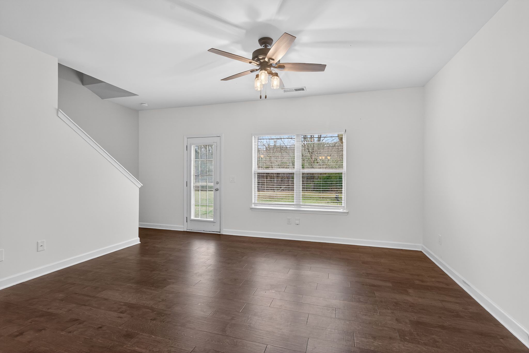 735 Tulip Grove Road, Unit 358 Hermitage, TN 37076 - Photo 6 of 37 an empty room with wooden floor chandelier fan and windows