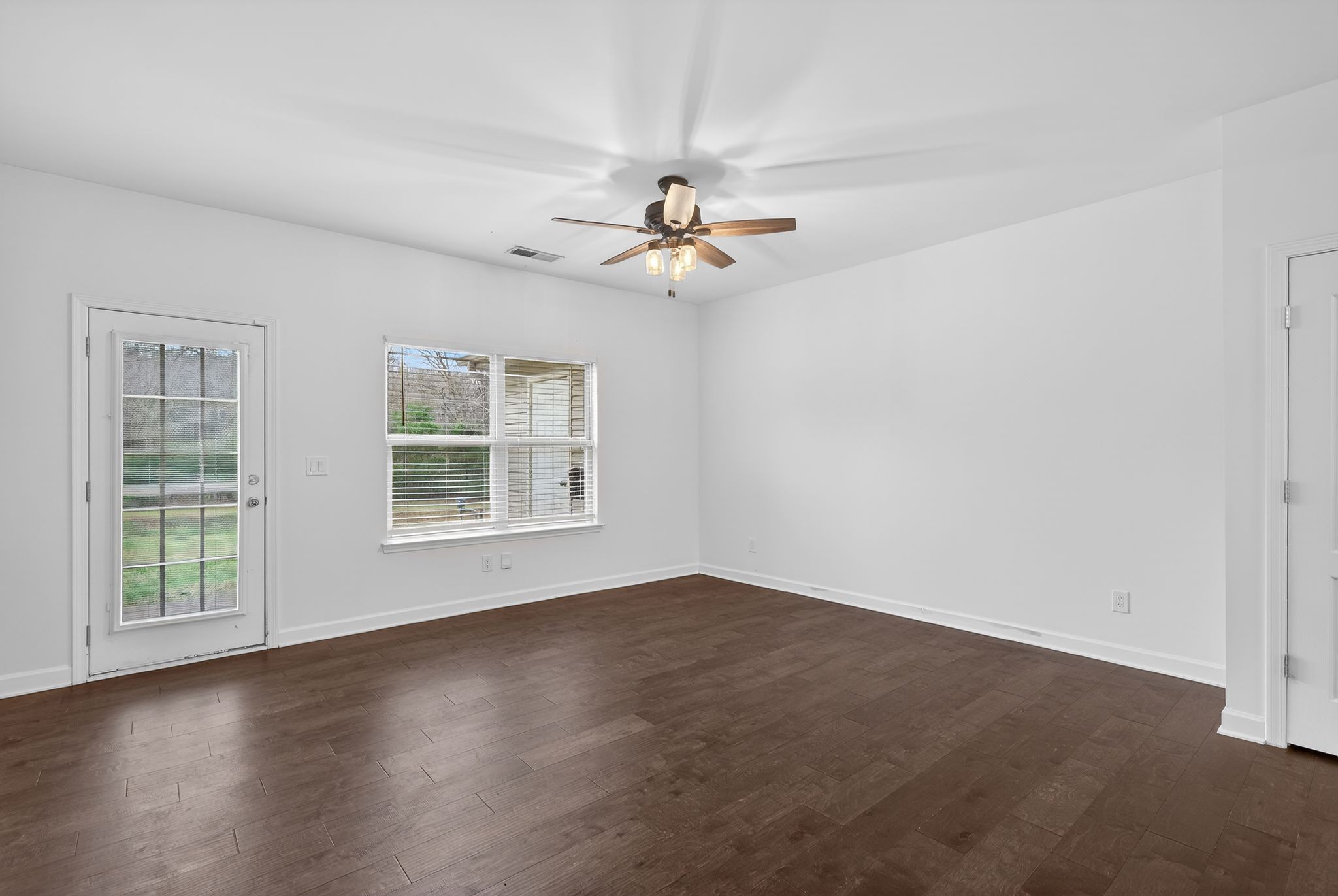 735 Tulip Grove Road, Unit 358 Hermitage, TN 37076 - Photo 7 of 37 a view of an empty room with windows and chandelier fan