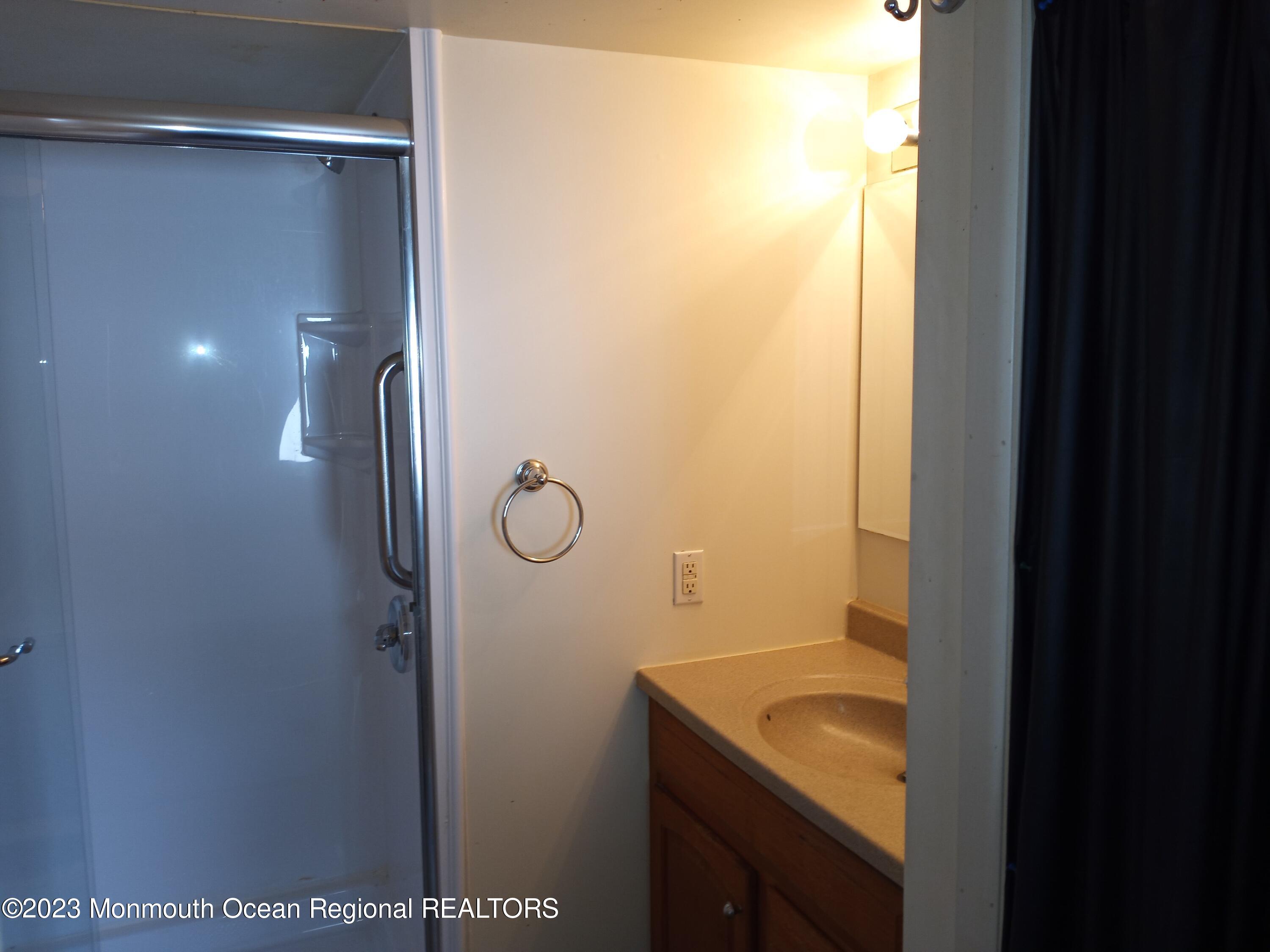 274 Lane C Hazlet, NJ 07730 - Photo 11 of 19 a bathroom with a granite countertop sink and mirror