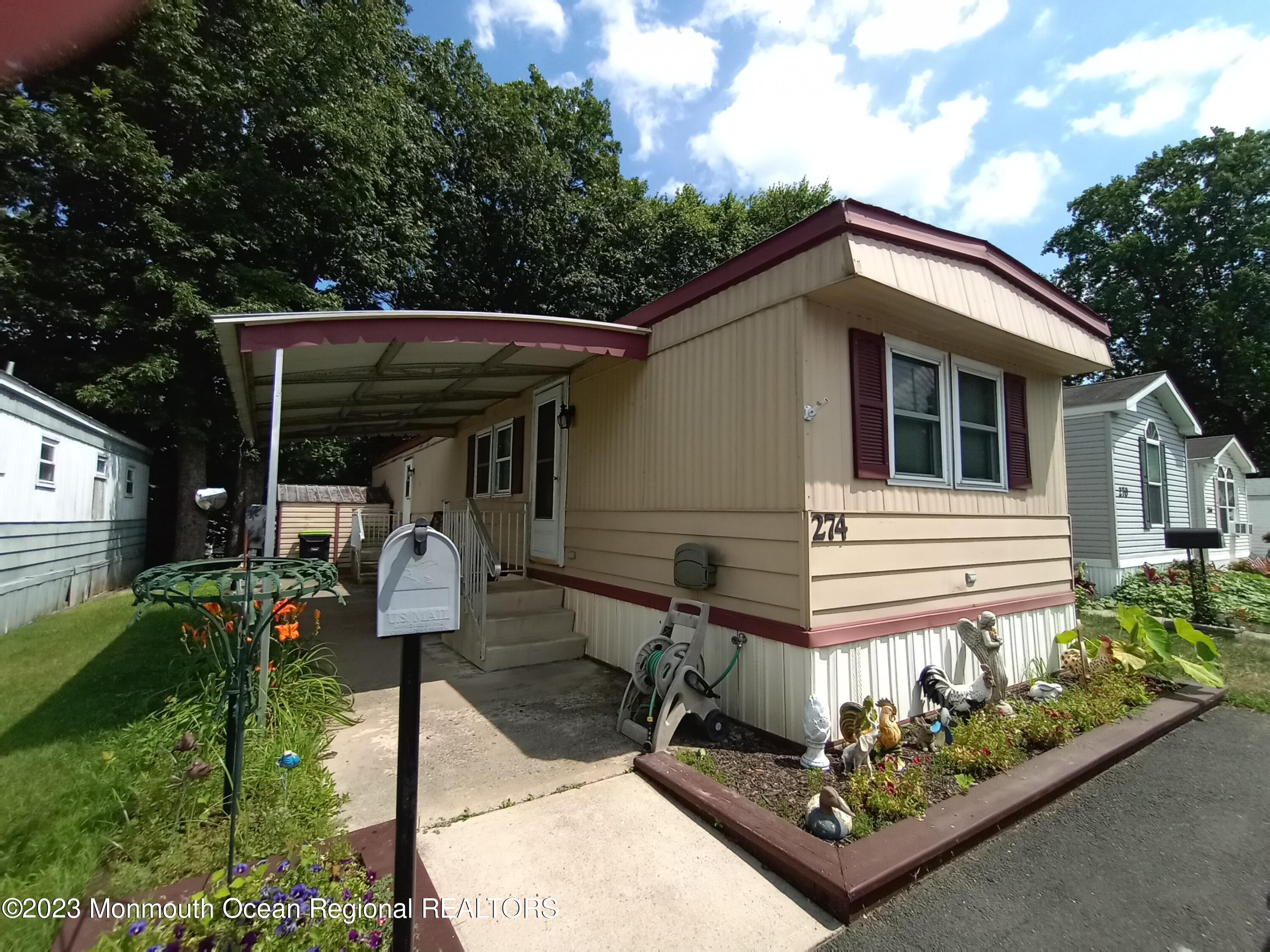 274 Lane C Hazlet, NJ 07730 - Photo 13 of 19 a front view of a house with garden