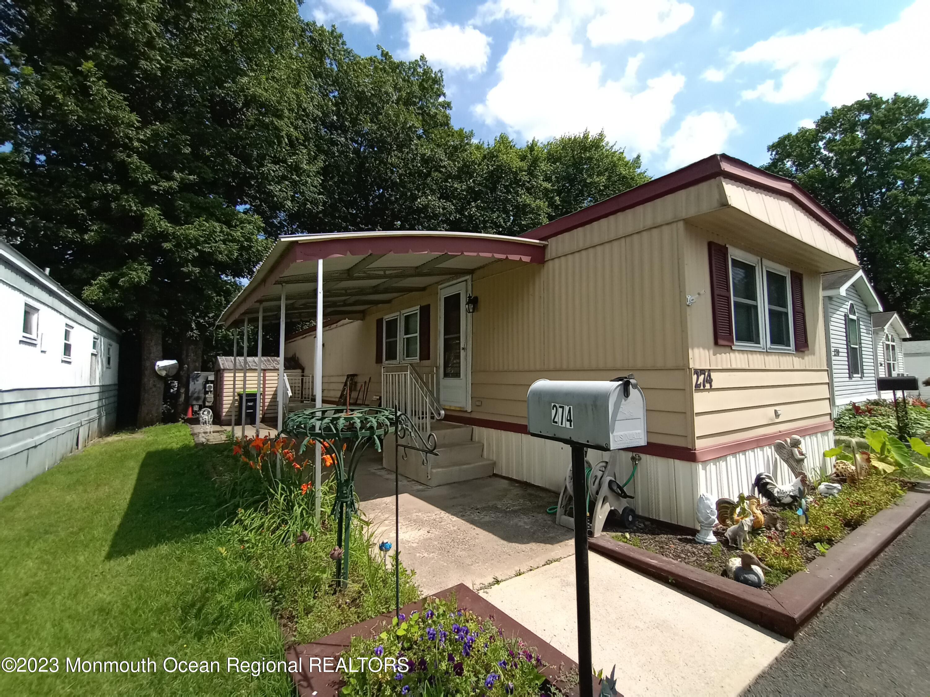 274 Lane C Hazlet, NJ 07730 - Photo 2 of 19 a front view of a house with garden
