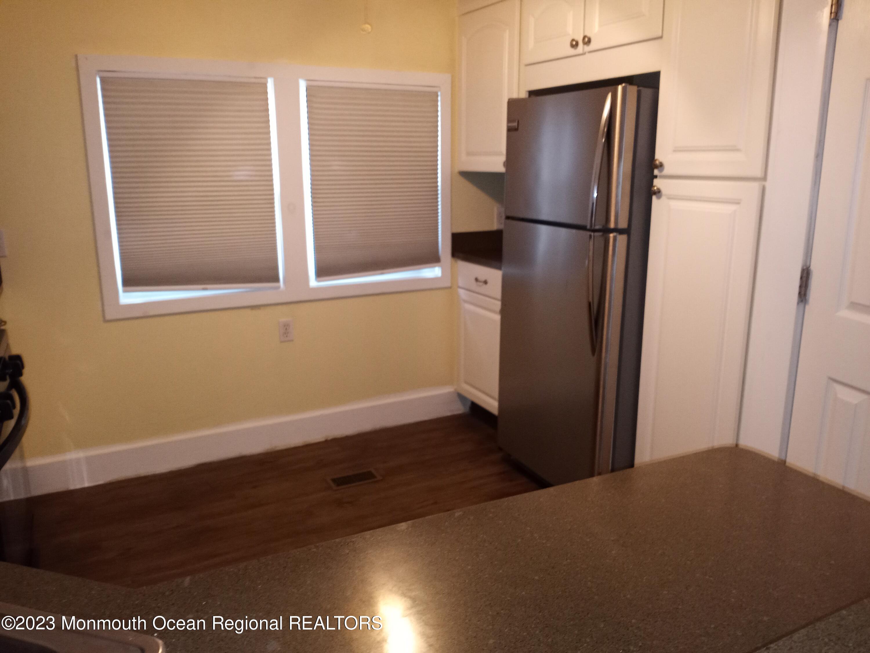 274 Lane C Hazlet, NJ 07730 - Photo 7 of 19 a kitchen with a refrigerator and cabinets