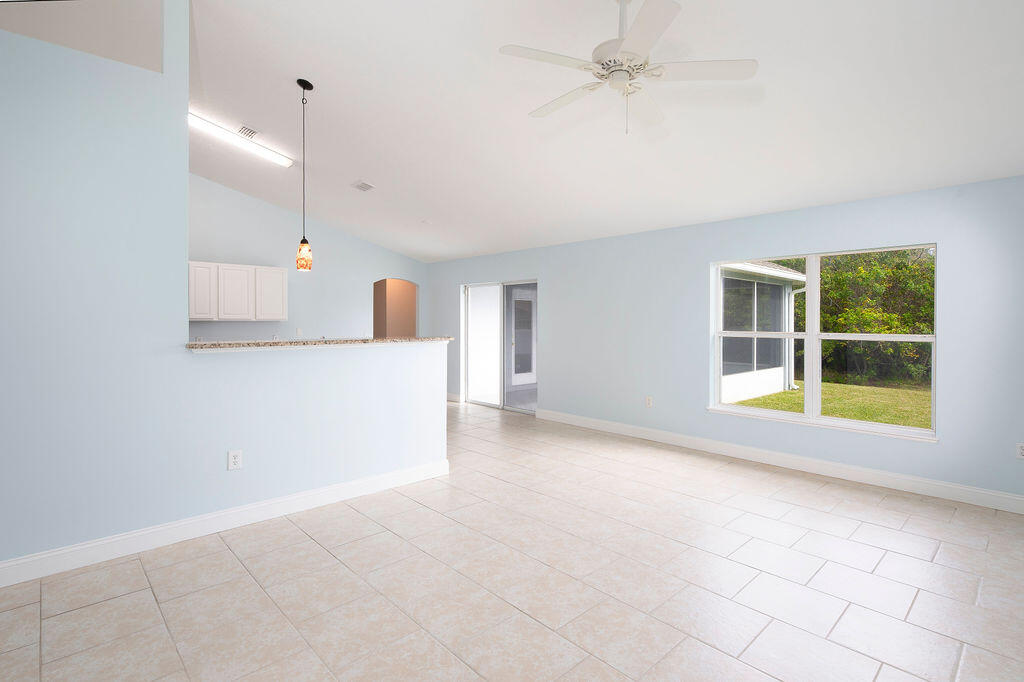 1815 Dragon Road Southeast Palm Bay, FL 32909 - Photo 17 of 41 an empty room with windows and entrance