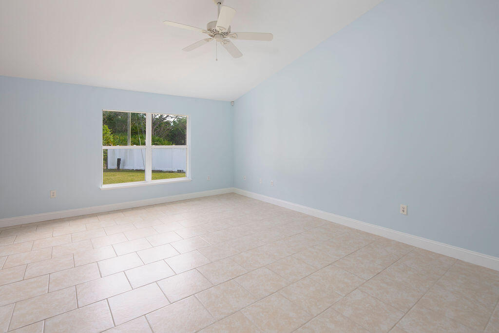 1815 Dragon Road Southeast Palm Bay, FL 32909 - Photo 18 of 41 en empty room with windows and fan