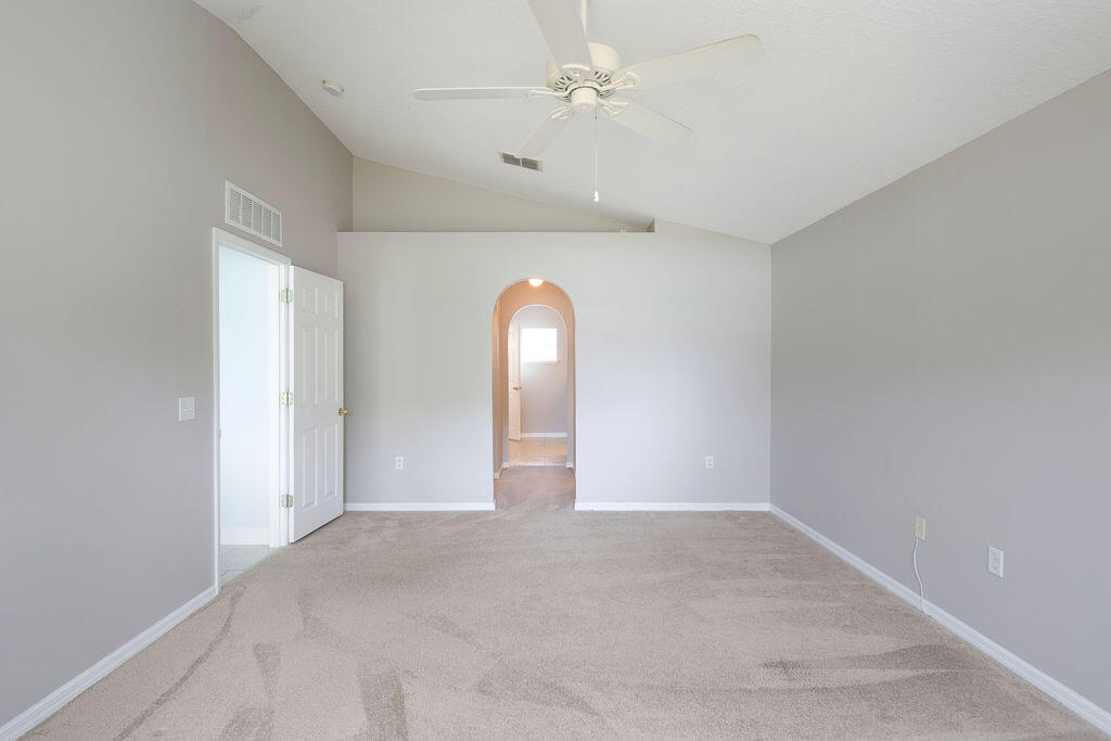 1815 Dragon Road Southeast Palm Bay, FL 32909 - Photo 21 of 41 an empty room with windows and fan
