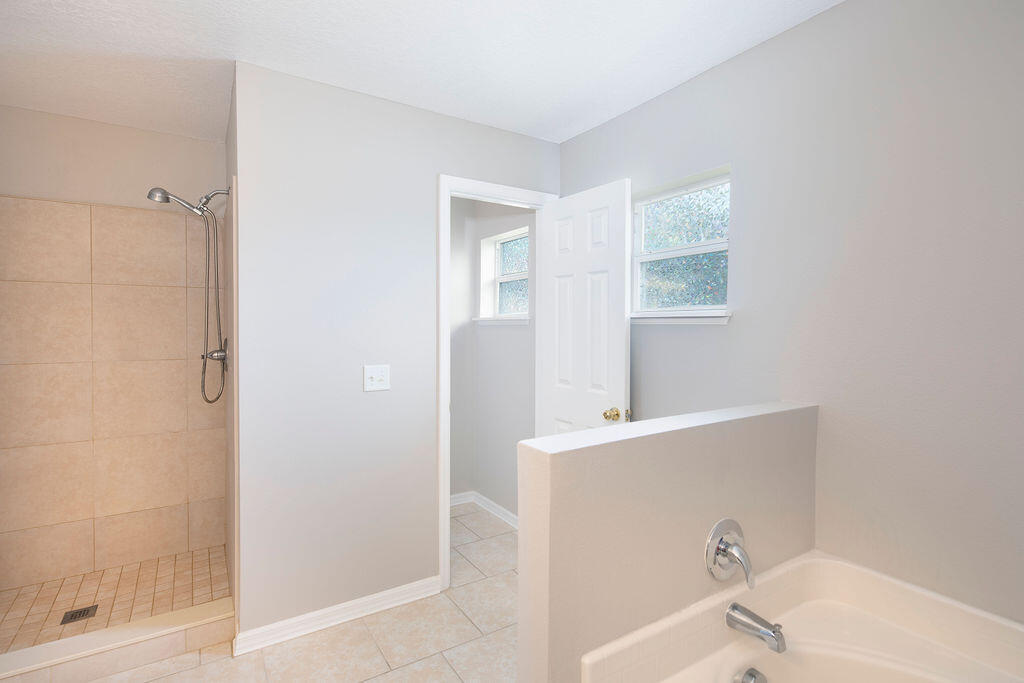 1815 Dragon Road Southeast Palm Bay, FL 32909 - Photo 25 of 41 a bathroom with a bathtub and a sink