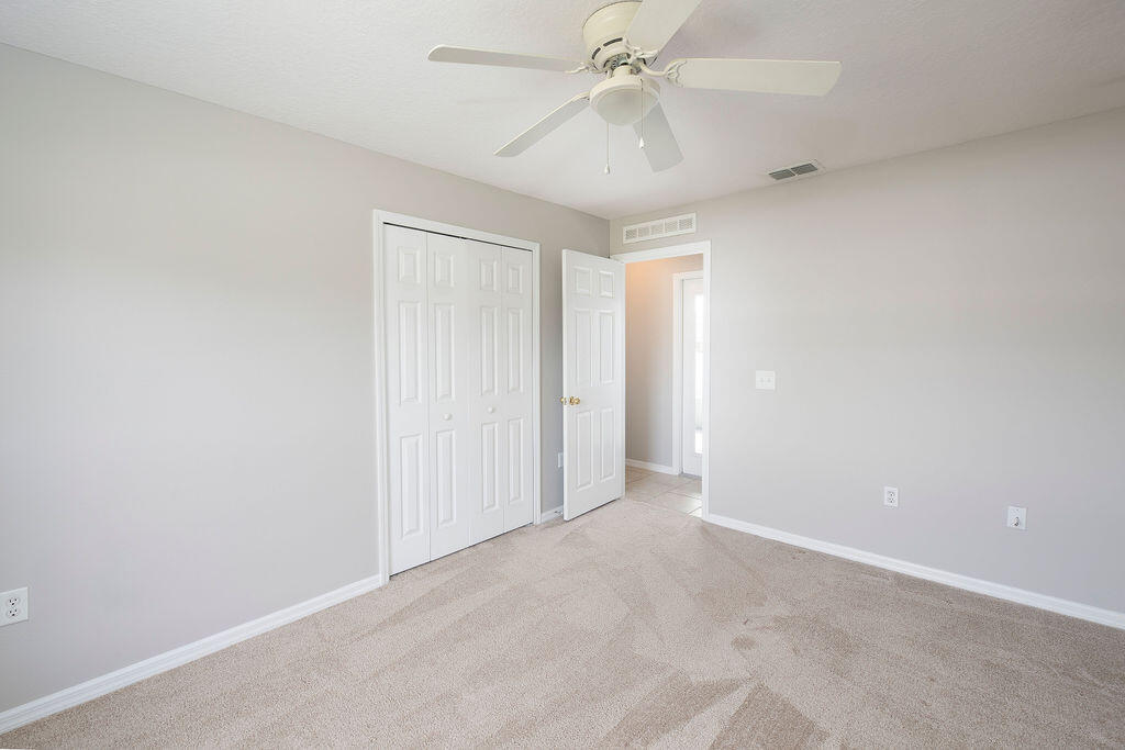 1815 Dragon Road Southeast Palm Bay, FL 32909 - Photo 28 of 41 an empty room with a ceiling fan and a fan