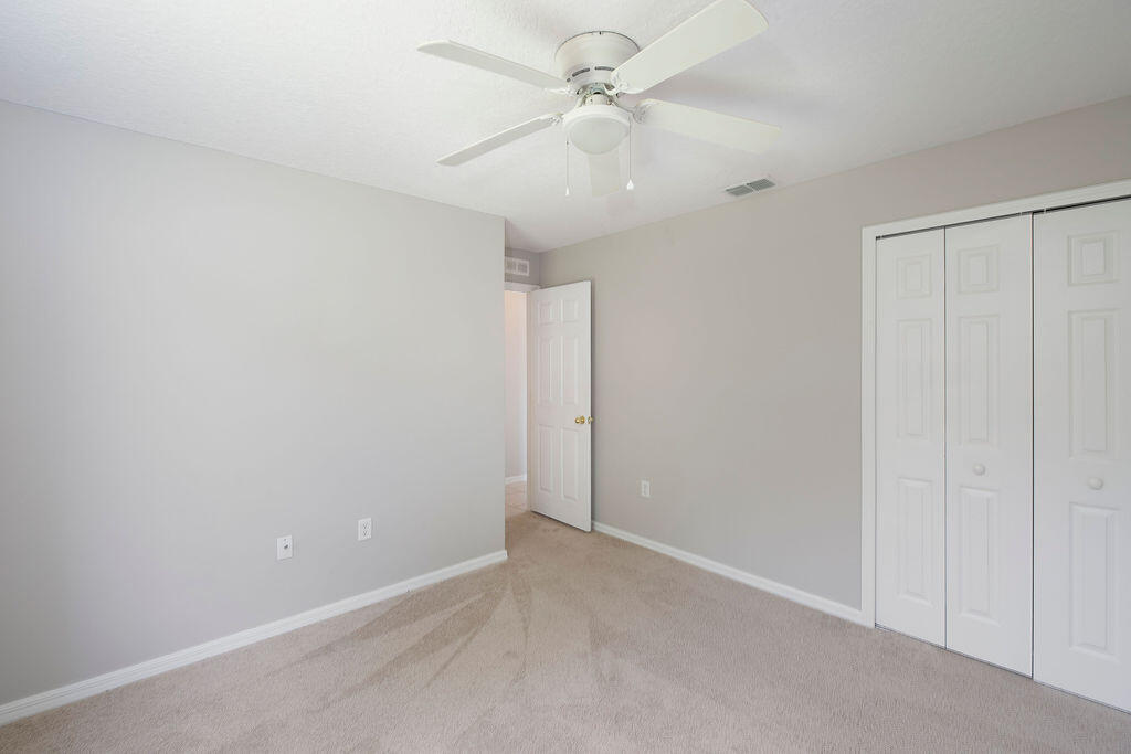 1815 Dragon Road Southeast Palm Bay, FL 32909 - Photo 30 of 41 an empty room with a ceiling fan and a window