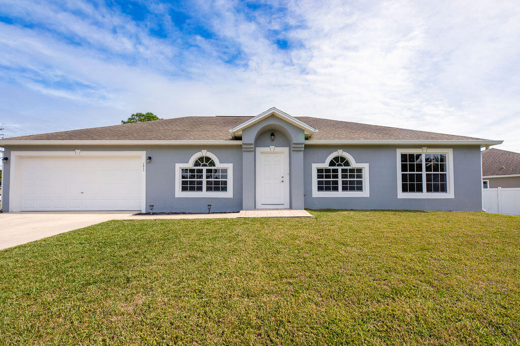 1815 Dragon Road Southeast Palm Bay, FL 32909 - Photo 3 of 41 a front view of a house with a garden