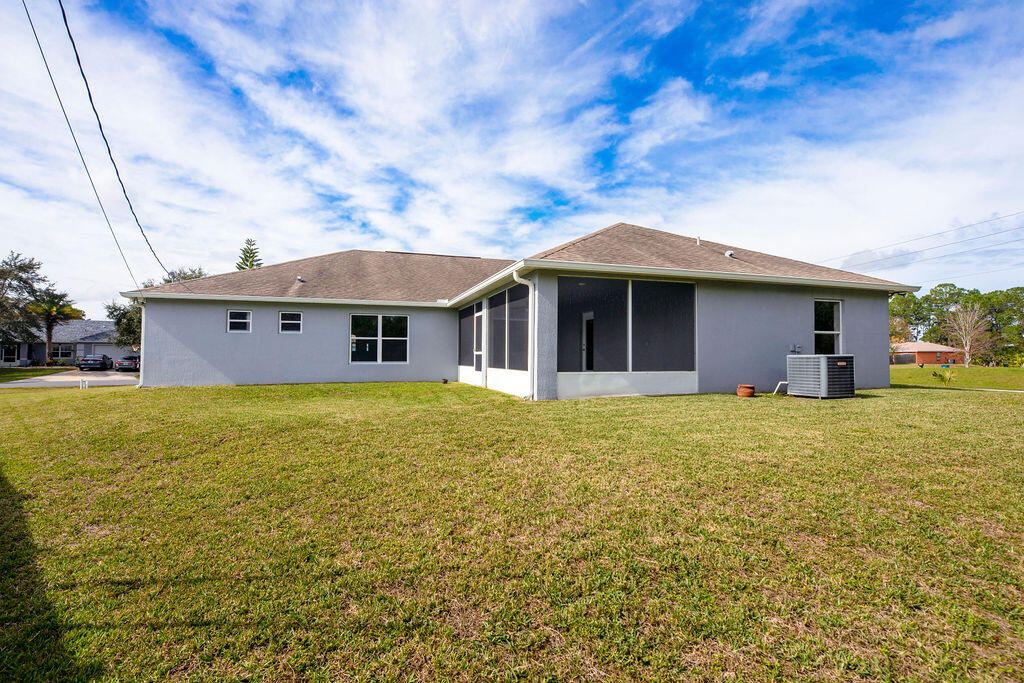 1815 Dragon Road Southeast Palm Bay, FL 32909 - Photo 33 of 41 a front view of a house with a garden