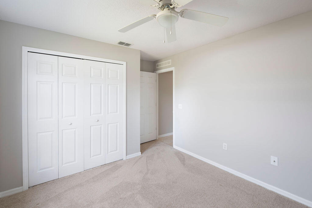 1815 Dragon Road Southeast Palm Bay, FL 32909 - Photo 36 of 41 an empty room with a ceiling fan and a window