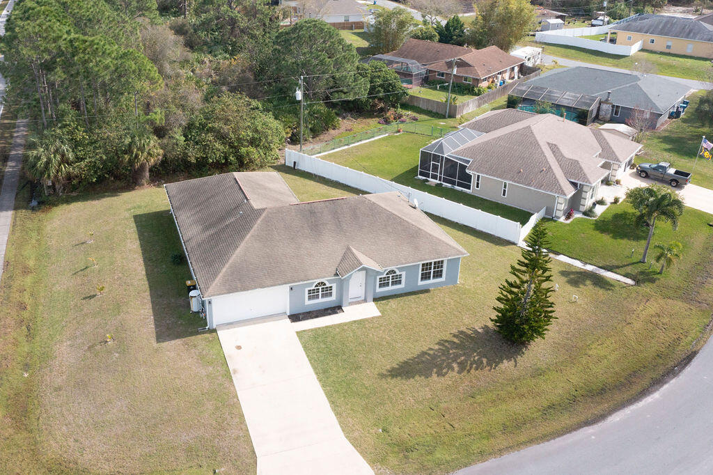 1815 Dragon Road Southeast Palm Bay, FL 32909 - Photo 39 of 41 an aerial view of a house with swimming pool and large trees