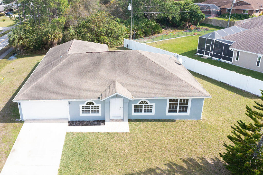 1815 Dragon Road Southeast Palm Bay, FL 32909 - Photo 41 of 41 a view of a house with pool and a yard