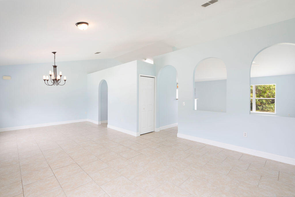1815 Dragon Road Southeast Palm Bay, FL 32909 - Photo 7 of 41 wooden floor in an empty room with a window