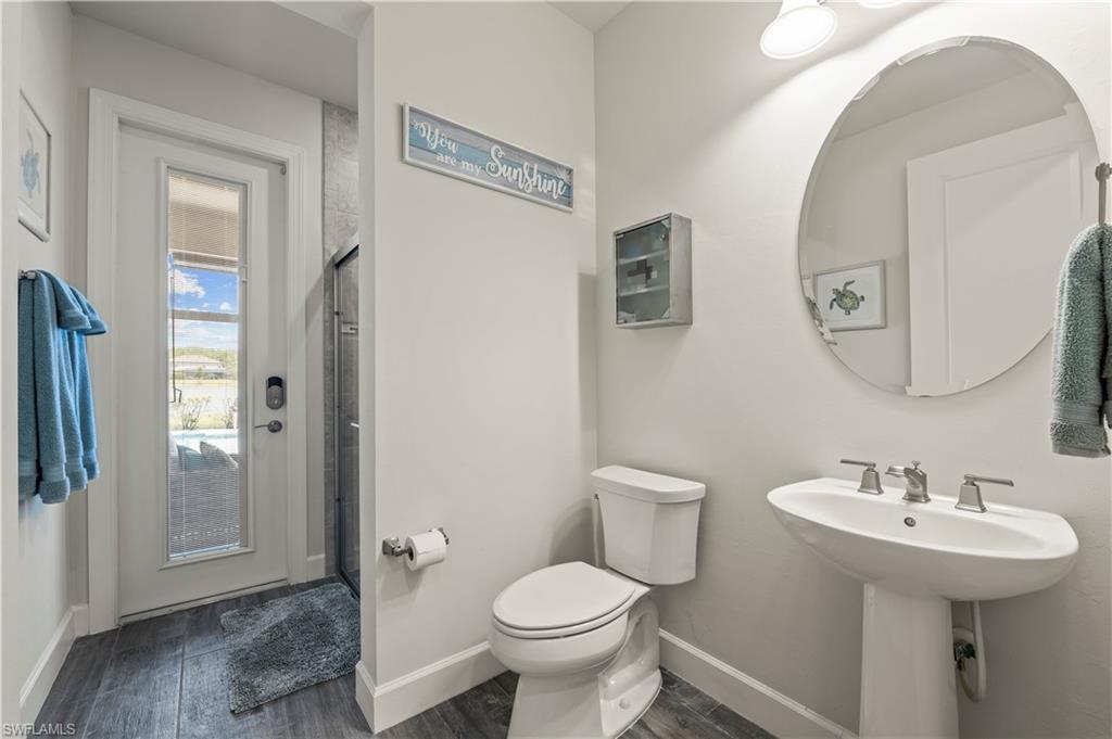 19157 Elston Way Estero, FL 33928 - Photo 12 of 50 a bathroom with a toilet sink and mirror