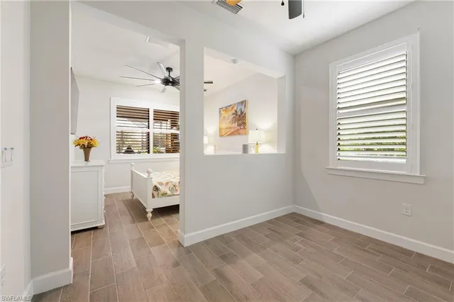an empty room with a window and wooden floor