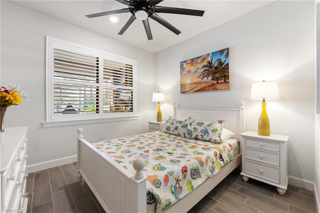 19157 Elston Way Estero, FL 33928 - Photo 14 of 50 a bedroom with a bed and a chandelier