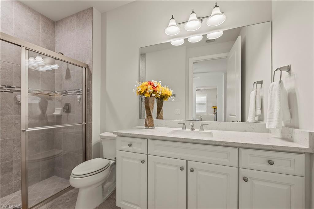 19157 Elston Way Estero, FL 33928 - Photo 15 of 50 a bathroom with a toilet sink and mirror