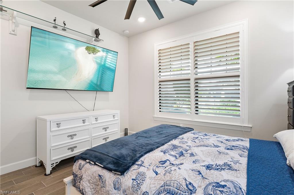 19157 Elston Way Estero, FL 33928 - Photo 17 of 50 a bedroom with a bed and a flat screen tv