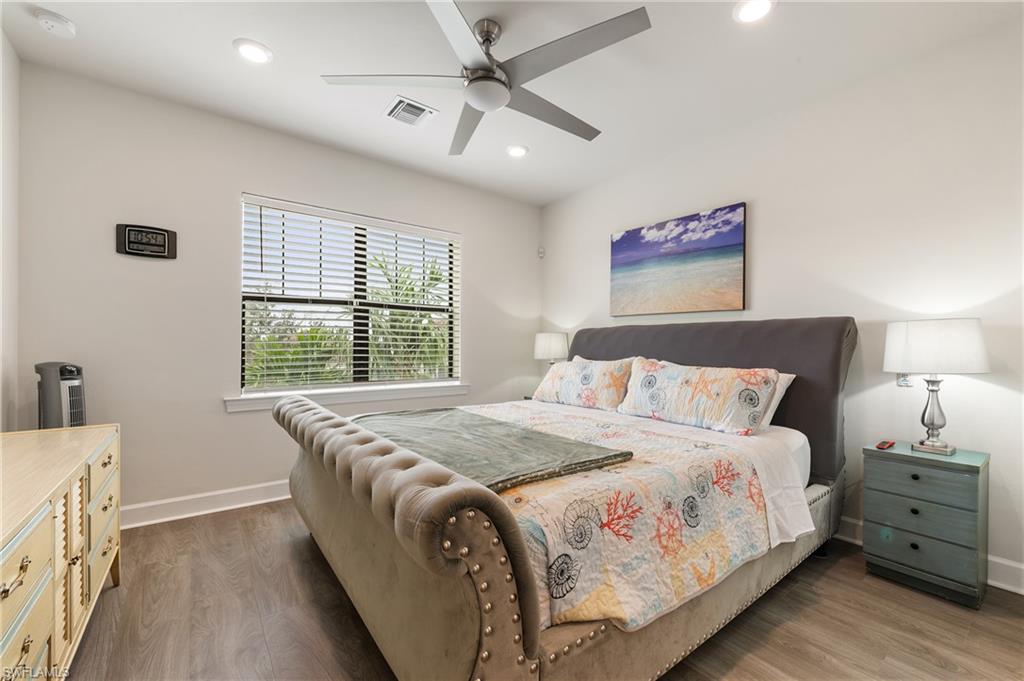 19157 Elston Way Estero, FL 33928 - Photo 25 of 50 a large bed sitting in a bedroom next to a window