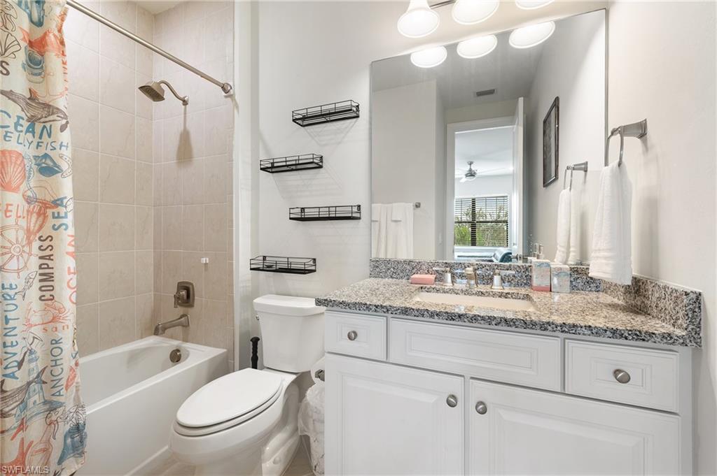 19157 Elston Way Estero, FL 33928 - Photo 26 of 50 a bathroom with a granite countertop toilet sink and mirror