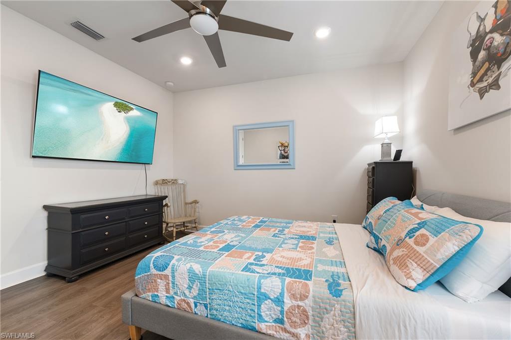 19157 Elston Way Estero, FL 33928 - Photo 28 of 50 a bedroom with a bed and a flat screen tv
