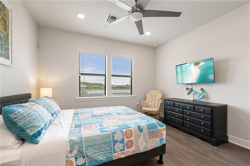 19157 Elston Way Estero, FL 33928 - Photo 31 of 50 a bedroom with a bed and a flat screen tv