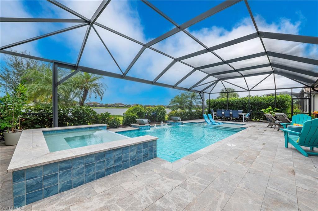 19157 Elston Way Estero, FL 33928 - Photo 32 of 50 a view of a backyard with lawn chairs under an umbrella