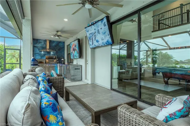 a living room with furniture and a floor to ceiling window
