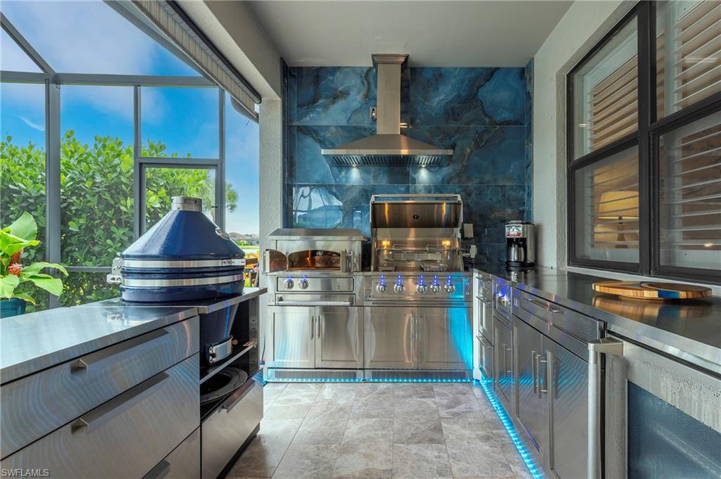 19157 Elston Way Estero, FL 33928 - Photo 39 of 50 a kitchen with stainless steel appliances granite countertop a sink and a stove