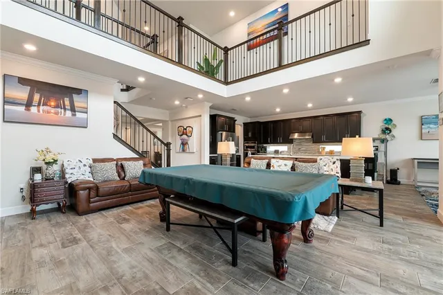a living room with furniture a table and kitchen view