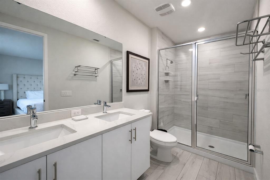7909 Draw Street Reunion, FL 34747 - Photo 12 of 12 a bathroom with a shower sink vanity mirror and toilet
