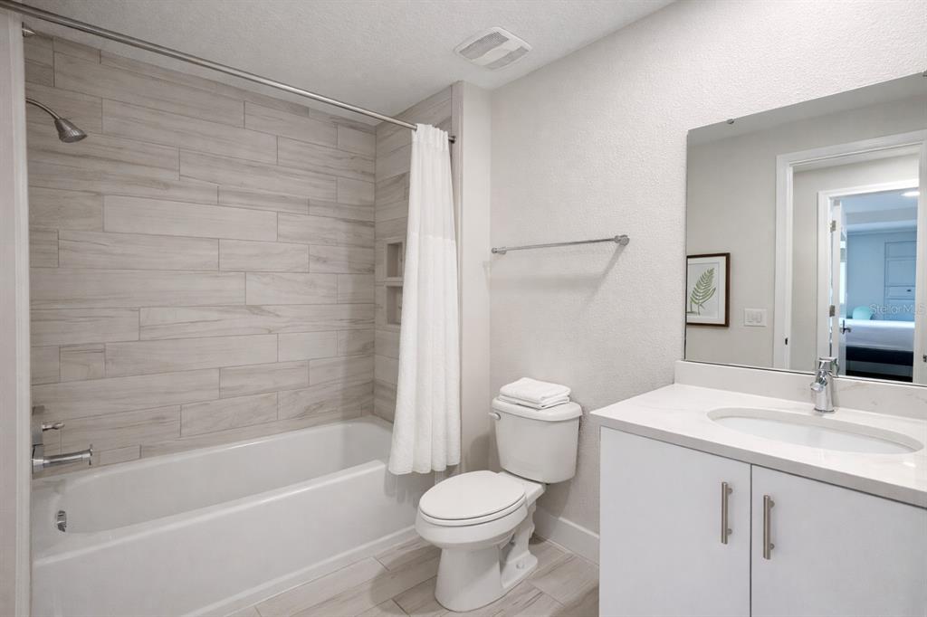 7909 Draw Street Reunion, FL 34747 - Photo 8 of 12 a bathroom with a sink toilet and shower