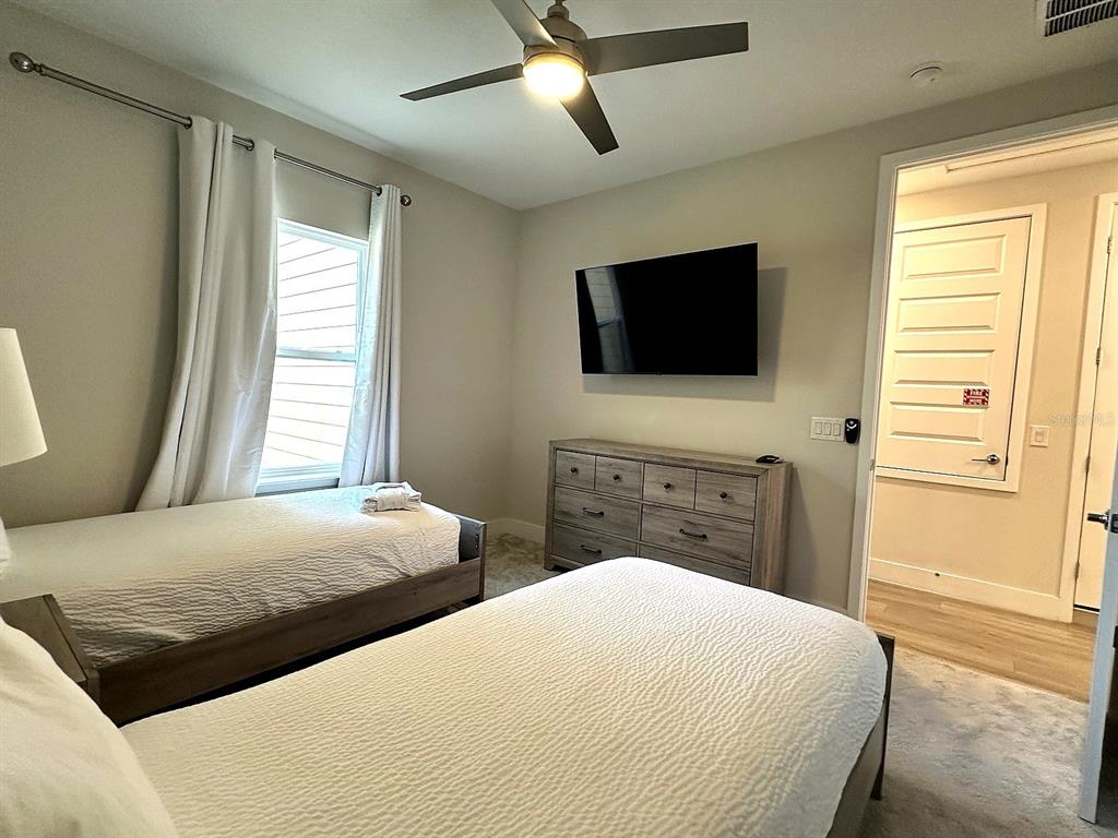 7909 Draw Street Reunion, FL 34747 - Photo 10 of 12 a bedroom with two bed and a flat screen tv