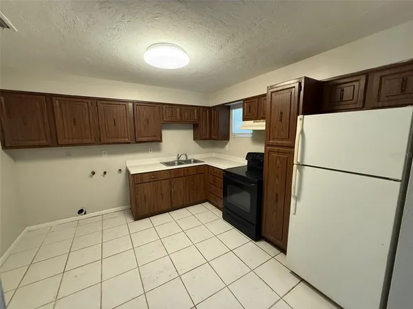 a kitchen with stainless steel appliances a refrigerator sink and cabinets