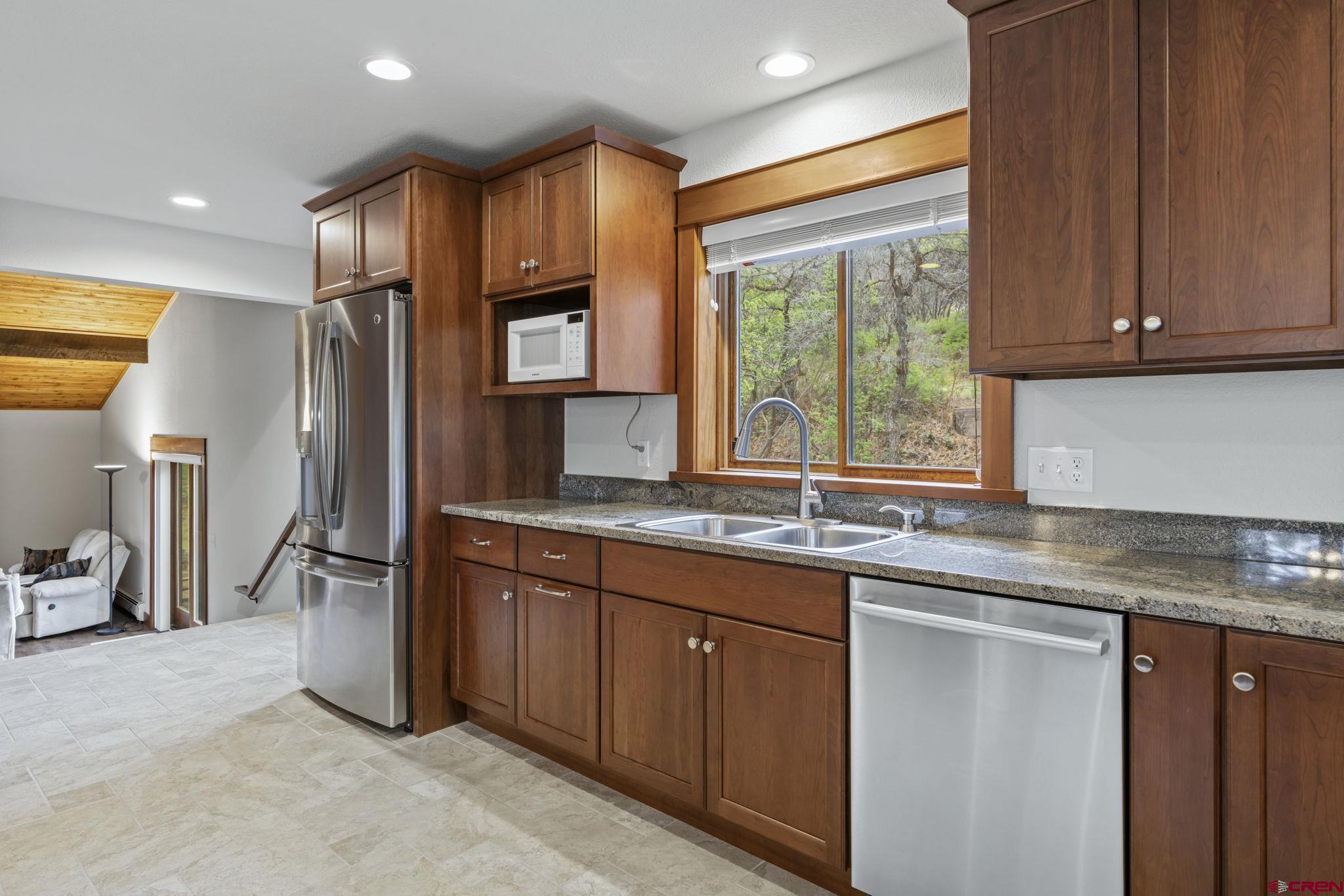 24 Songbird Lane Durango, CO 81301 - Photo 17 of 45 a kitchen with stainless steel appliances granite countertop a sink stove and refrigerator