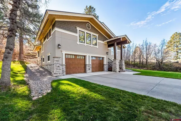 a bathroom with a tub a double vanity sink and a mirror