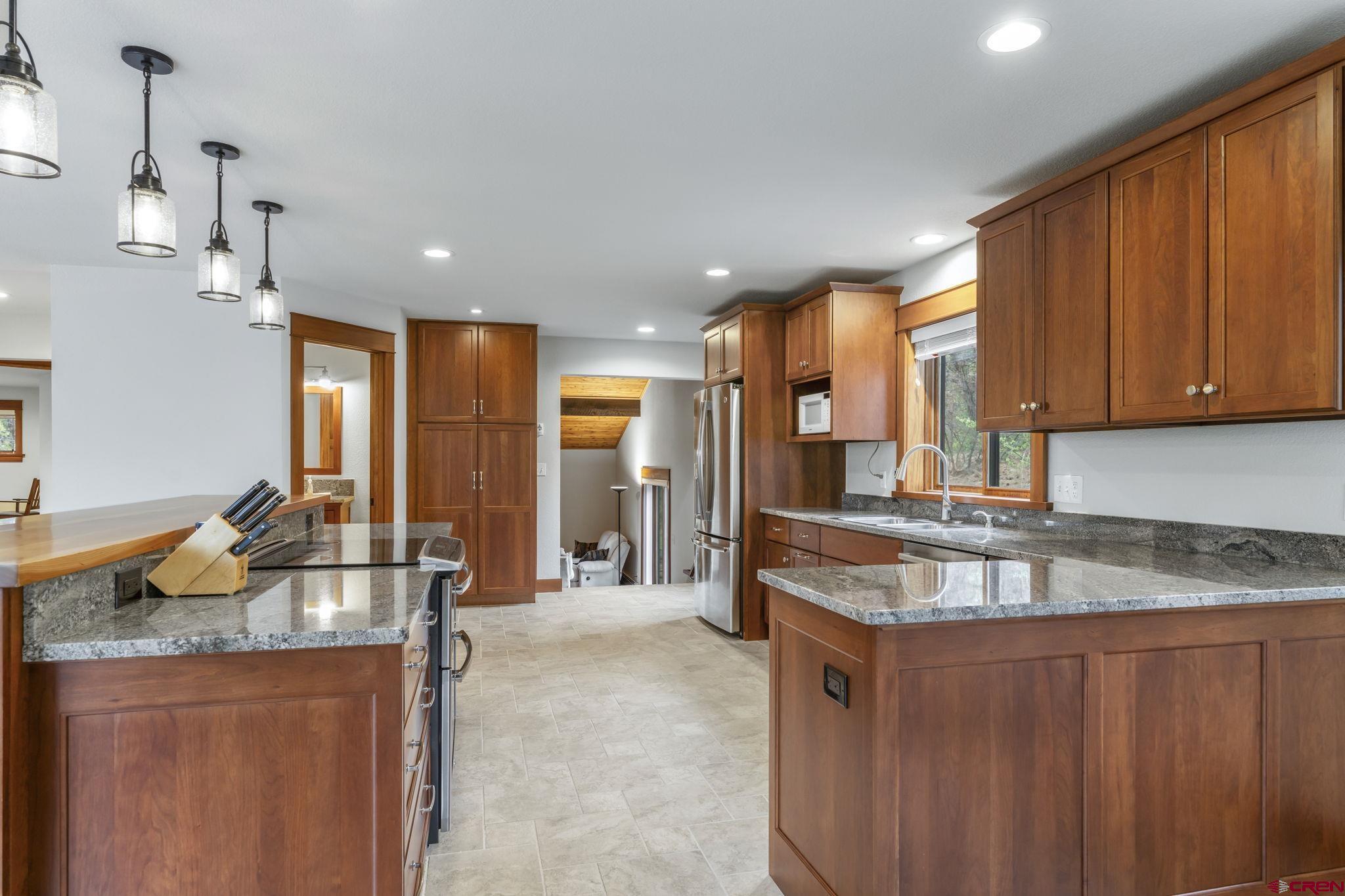 24 Songbird Lane Durango, CO 81301 - Photo 25 of 45 a kitchen with stainless steel appliances granite countertop a sink a stove and a refrigerator