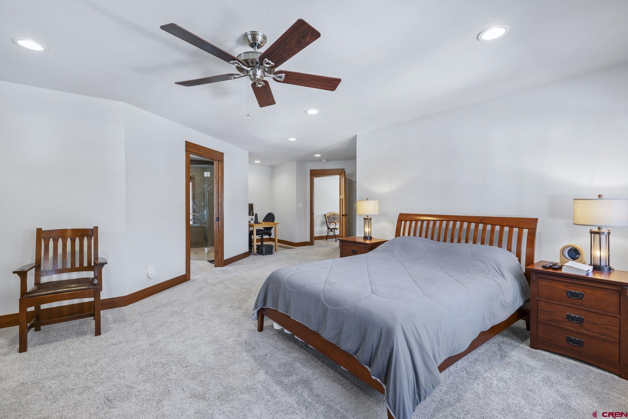 24 Songbird Lane Durango, CO 81301 - Photo 29 of 45 a spacious bedroom with a bed and a chandelier