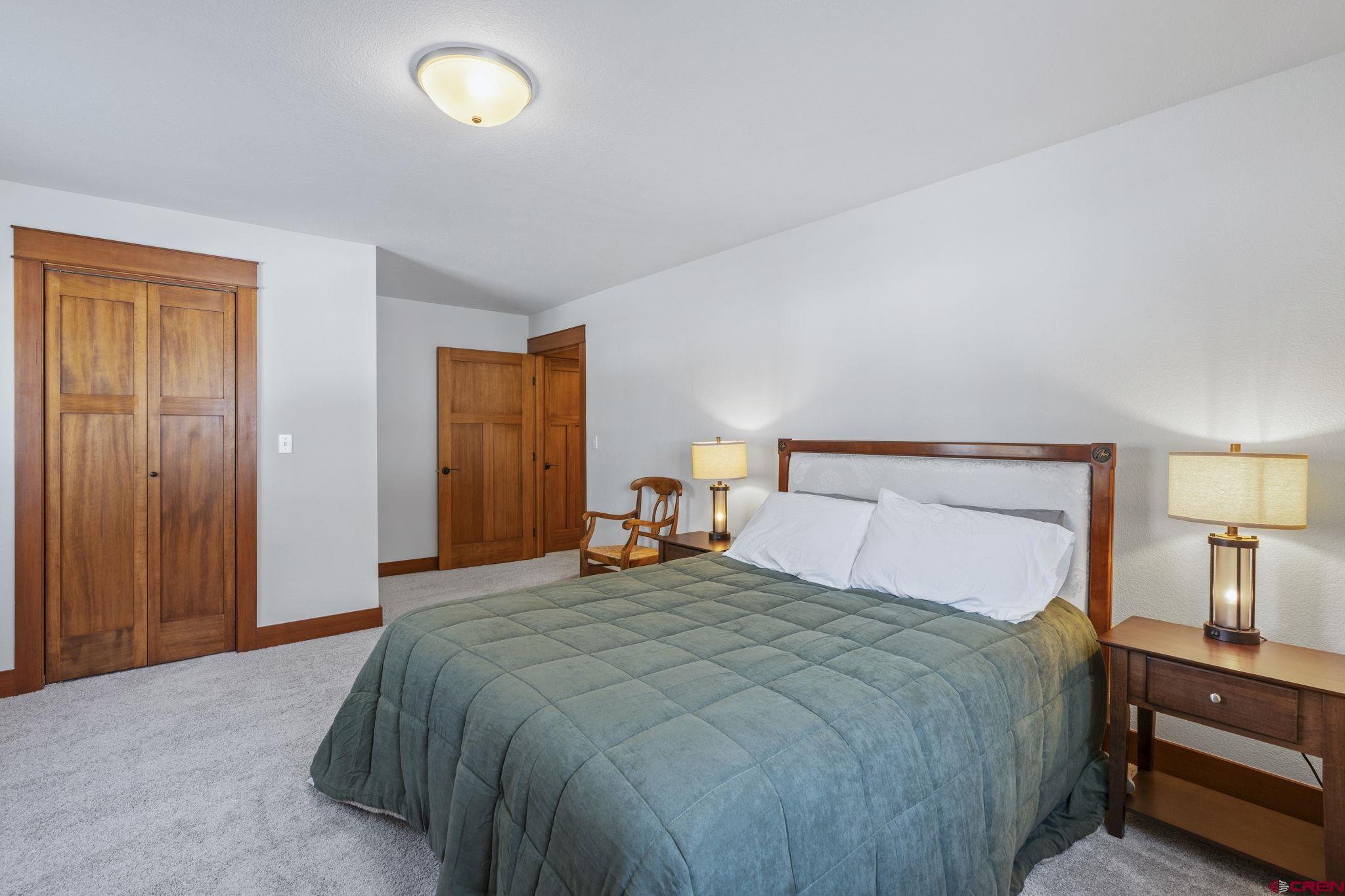24 Songbird Lane Durango, CO 81301 - Photo 37 of 45 a bedroom with a bed and a lamp