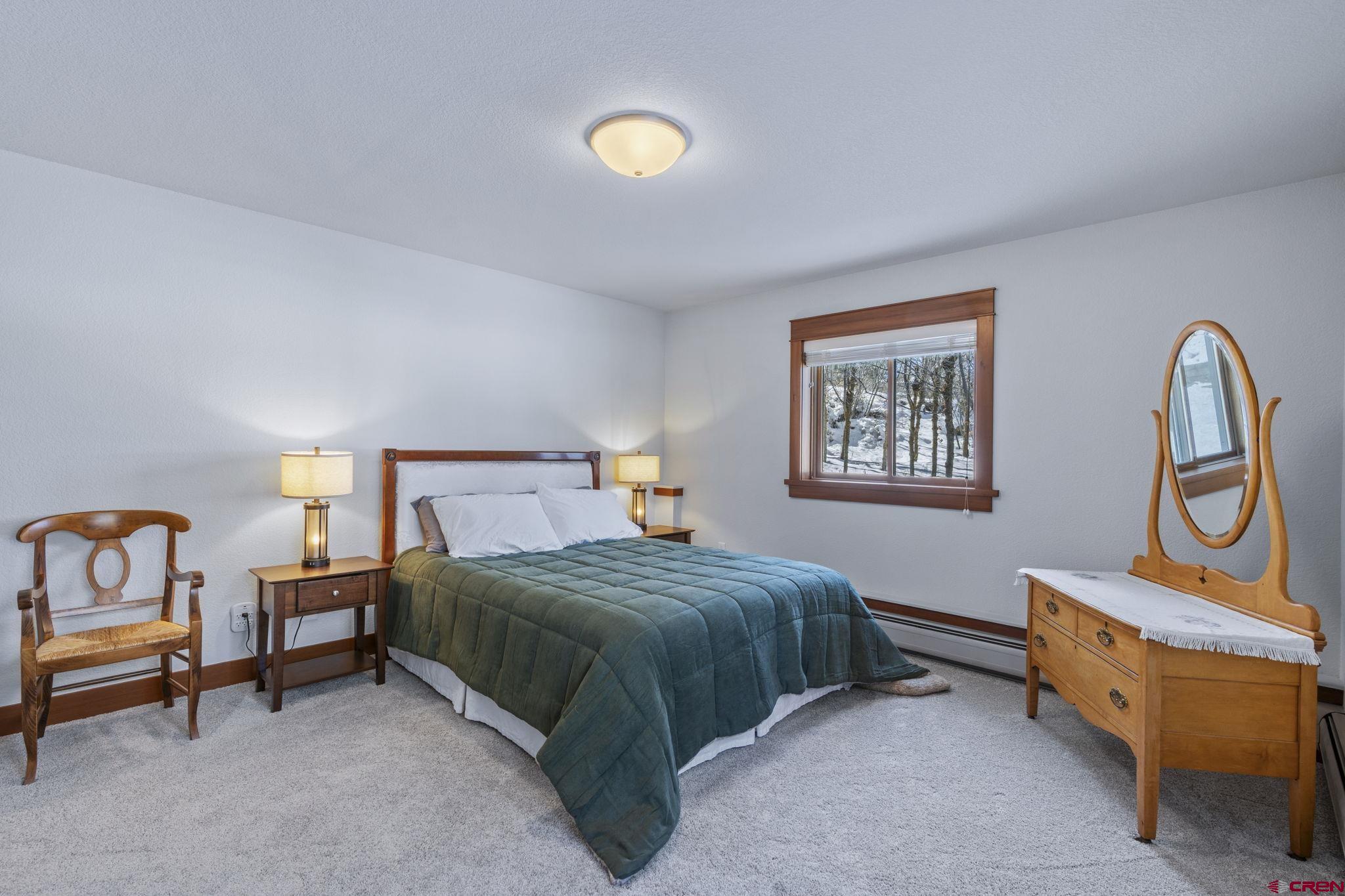 24 Songbird Lane Durango, CO 81301 - Photo 38 of 45 a bedroom with a bed a lamp and a dresser