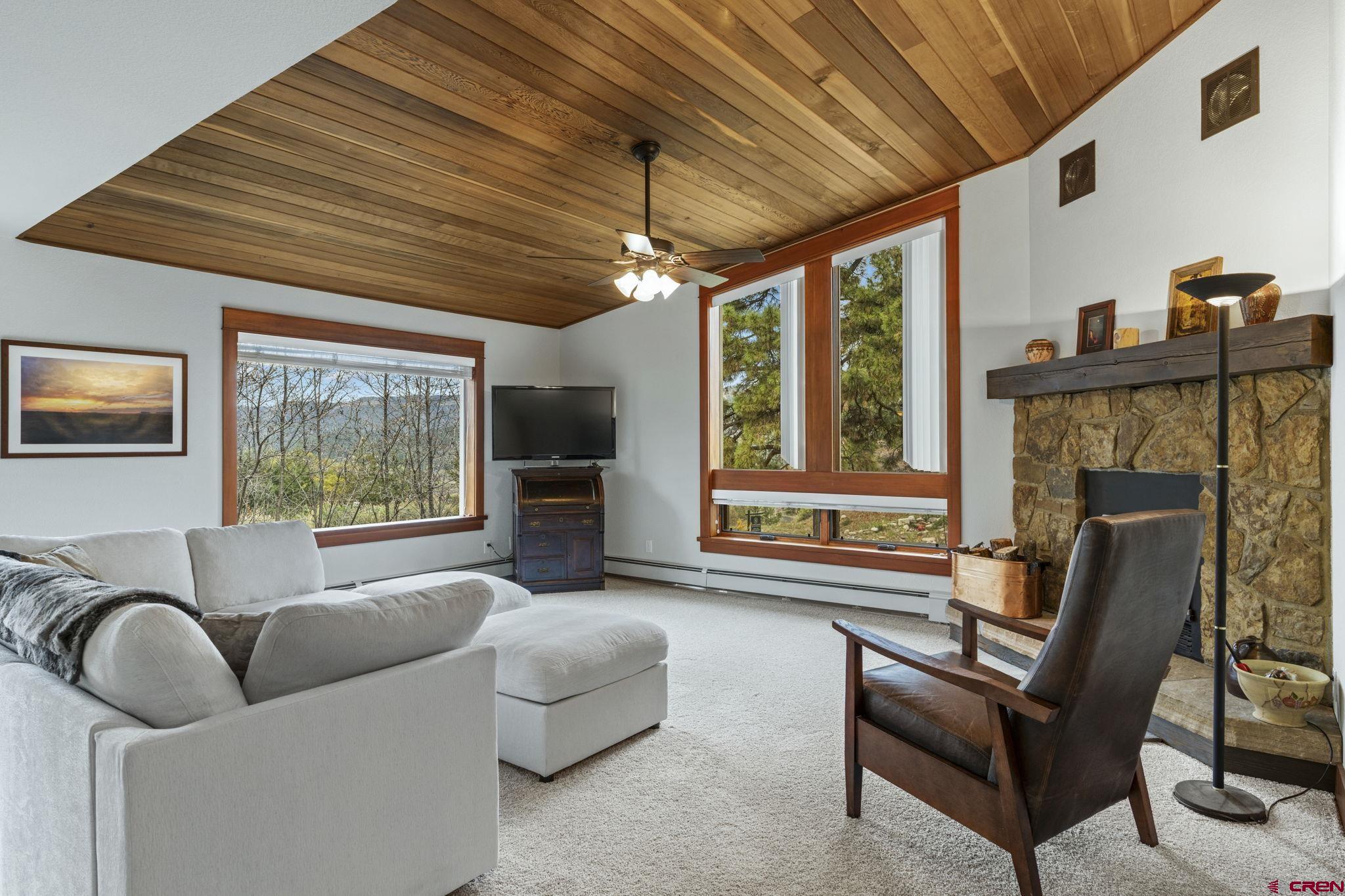 24 Songbird Lane Durango, CO 81301 - Photo 10 of 45 a living room with furniture a fireplace and windows