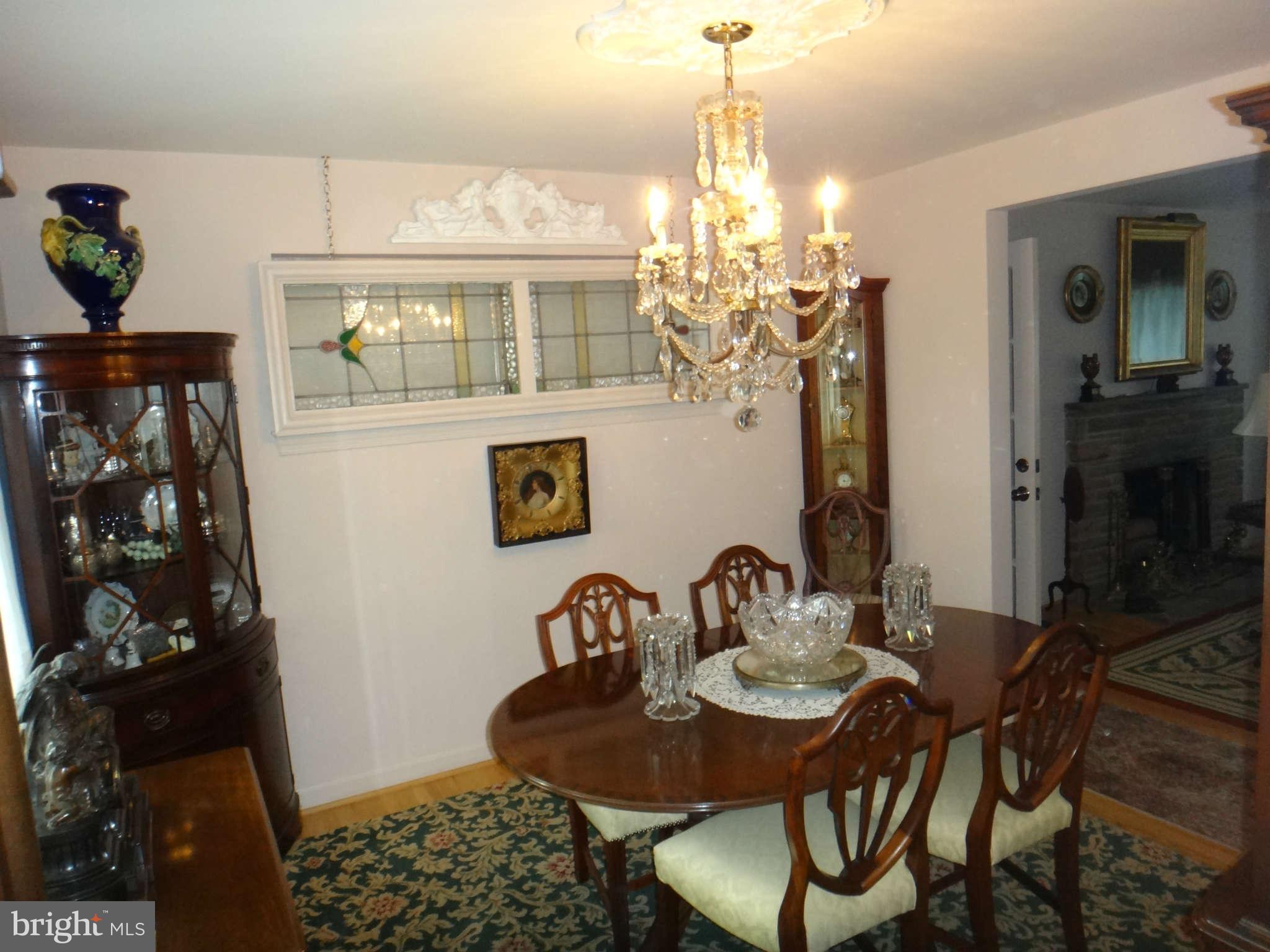 10128 Riggs Road Adelphi, MD 20783 - Photo 13 of 30 a view of a dining room with furniture and chandelier